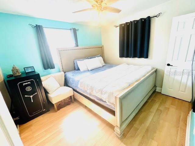 bedroom featuring ceiling fan and light hardwood / wood-style floors