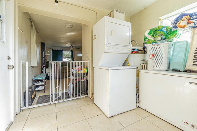 9696 Groveland St, Seminole, FL 33772 - laundry area with stacked washer and dryer and light tile patterned flooring