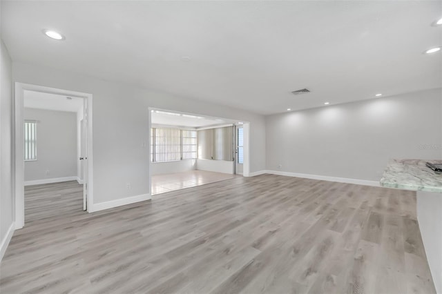 unfurnished living room featuring light hardwood / wood-style floors