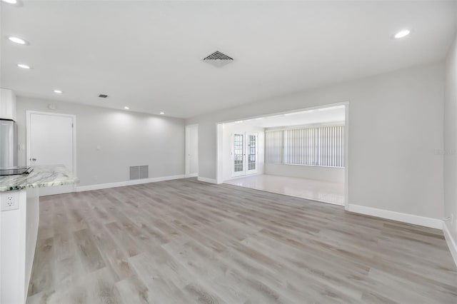 unfurnished living room featuring light hardwood / wood-style floors