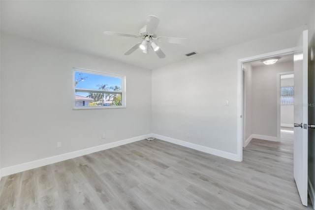 spare room featuring light hardwood / wood-style flooring and ceiling fan