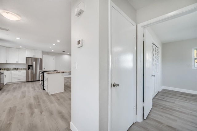 hall with light hardwood / wood-style flooring