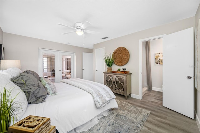 bedroom with french doors, visible vents, a ceiling fan, wood finished floors, and baseboards