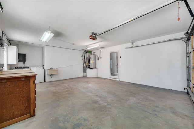 garage with a sink, water heater, washing machine and clothes dryer, and a garage door opener