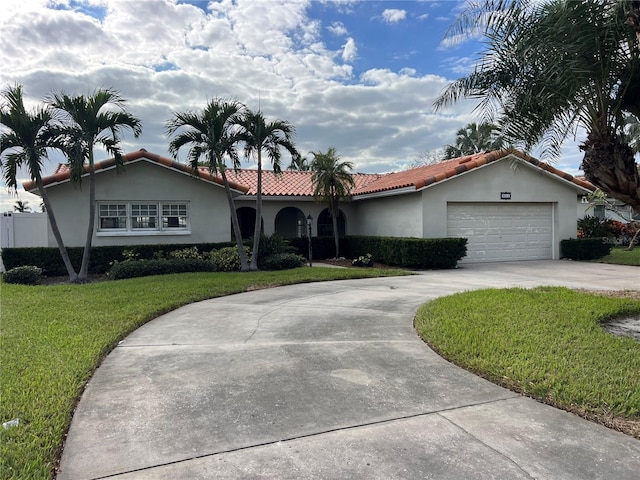 view of front of property featuring a garage and a front lawn