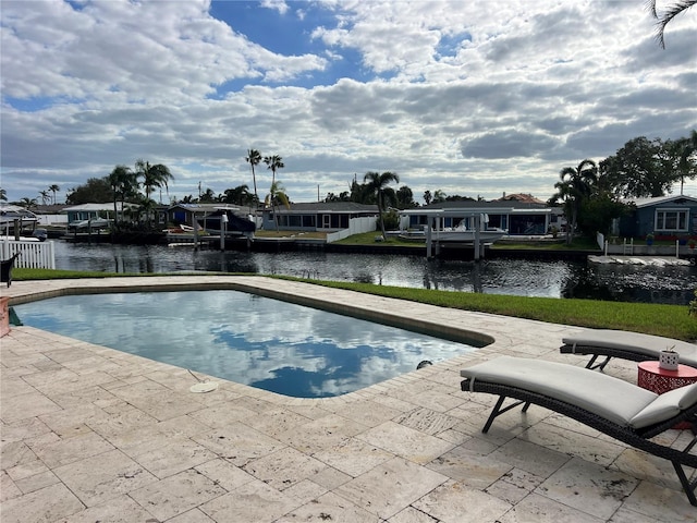 view of pool featuring a patio and a water view