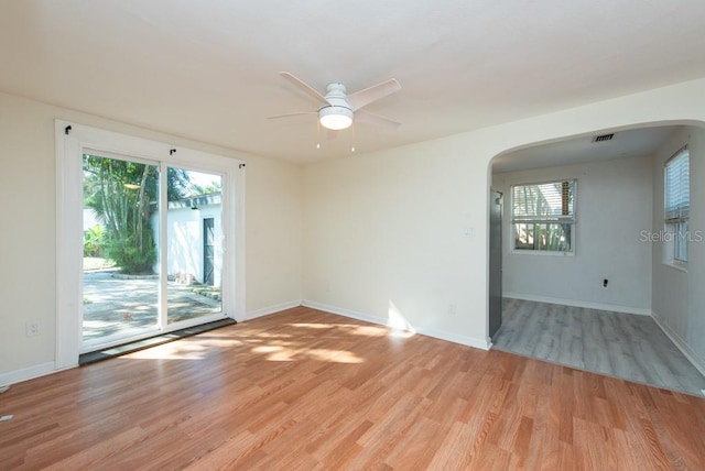 spare room featuring light hardwood / wood-style floors, plenty of natural light, and ceiling fan