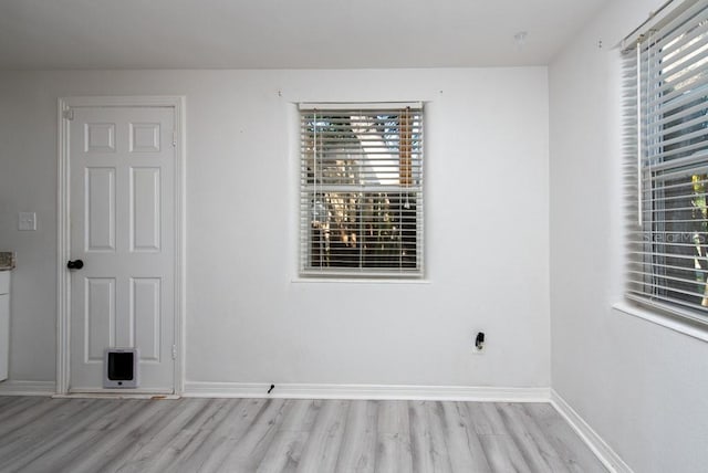 spare room with light hardwood / wood-style flooring