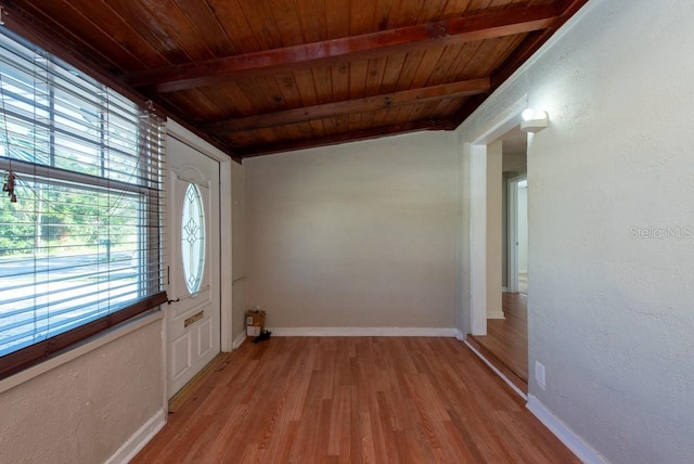 doorway to outside with lofted ceiling with beams, wood ceiling, and light hardwood / wood-style floors