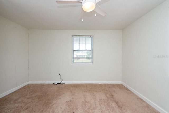 empty room featuring light colored carpet and ceiling fan