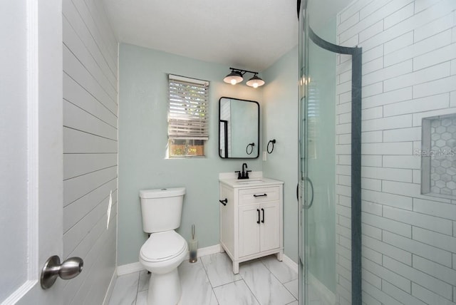 bathroom with vanity, an enclosed shower, and toilet