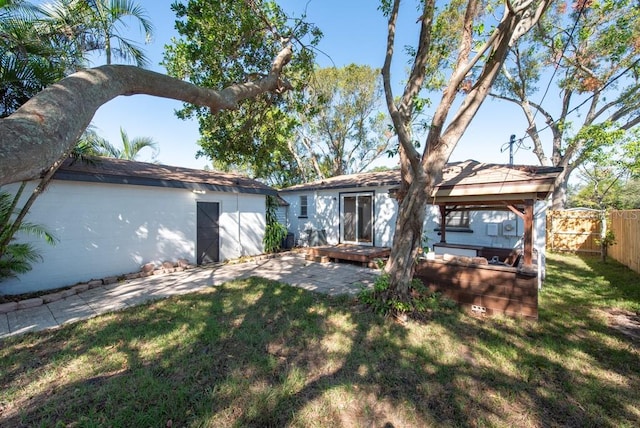 rear view of property with a yard and a patio