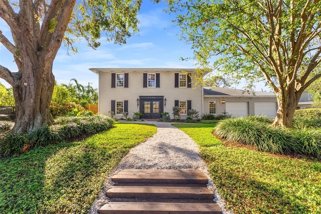 view of front of property featuring french doors and a garage