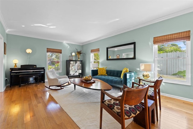 living room with light wood-type flooring and ornamental molding