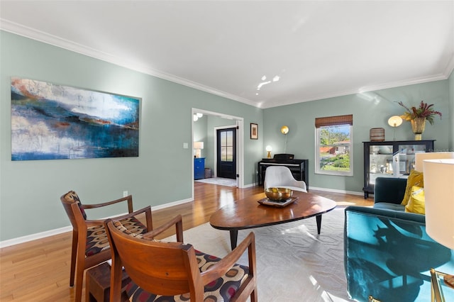 living room with crown molding and light wood-type flooring