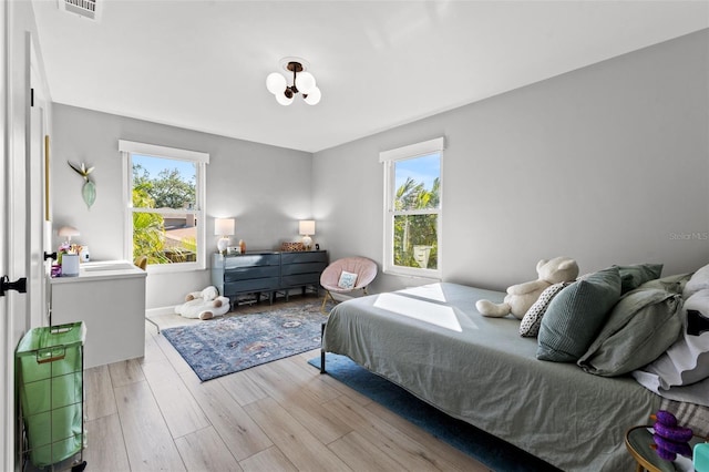 bedroom featuring light wood-type flooring and multiple windows