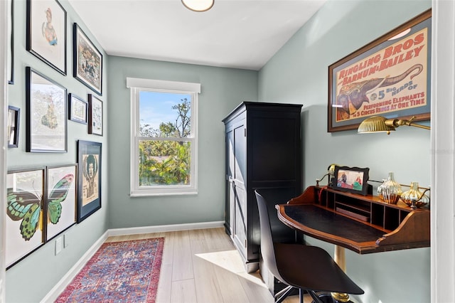 home office with light hardwood / wood-style floors