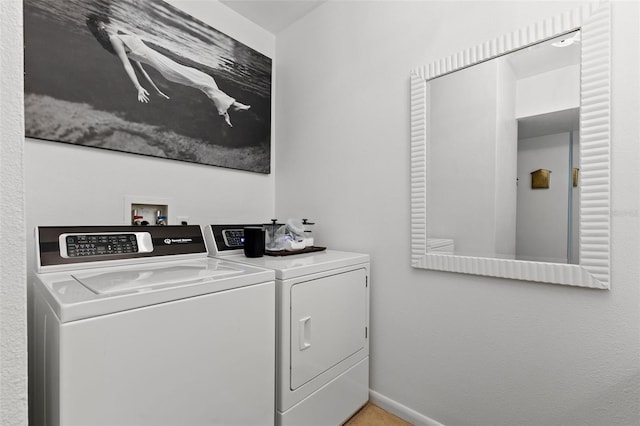 clothes washing area with washer and dryer