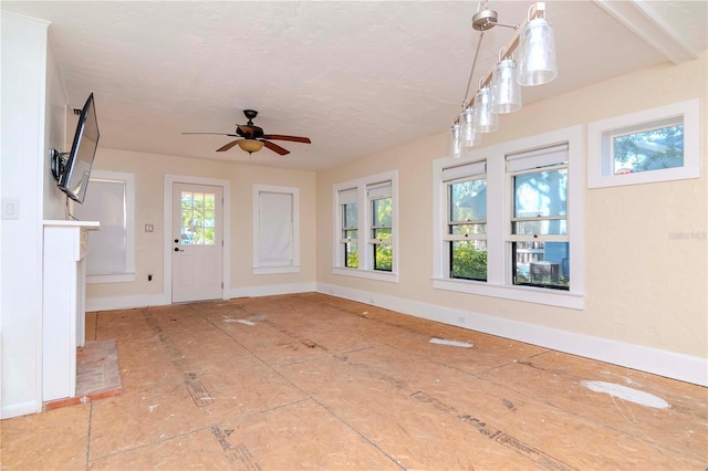 interior space featuring ceiling fan and a wealth of natural light