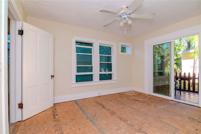 empty room with baseboards and a ceiling fan