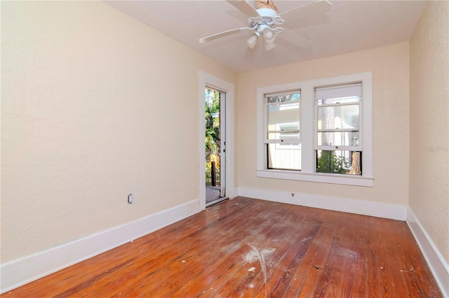 unfurnished room with ceiling fan, baseboards, and hardwood / wood-style flooring