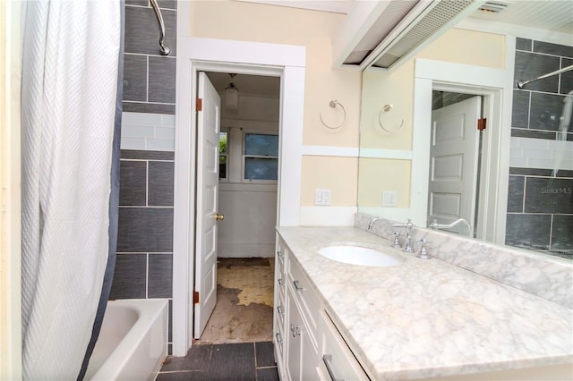 full bathroom featuring wood finished floors, vanity, and shower / tub combo with curtain