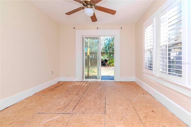 empty room with baseboards and a ceiling fan