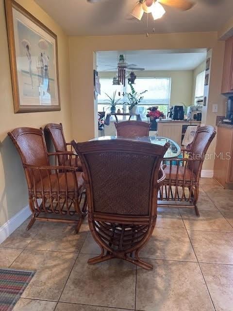 tiled dining room with ceiling fan