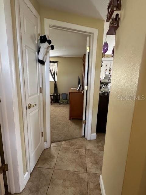 hallway featuring light colored carpet