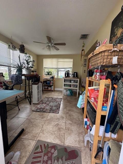 interior space featuring tile patterned floors and ceiling fan