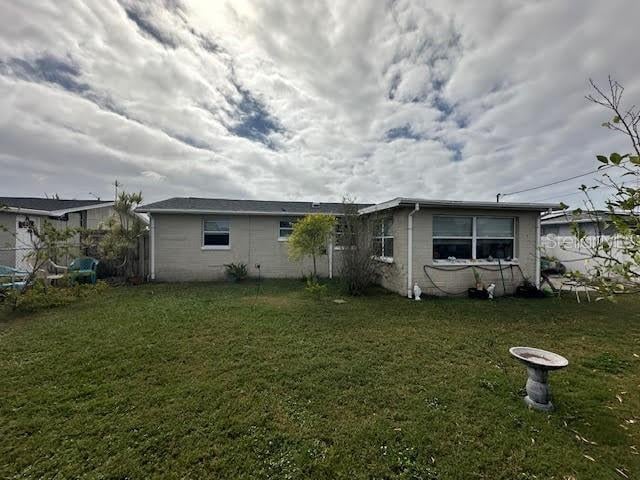 rear view of house with a yard