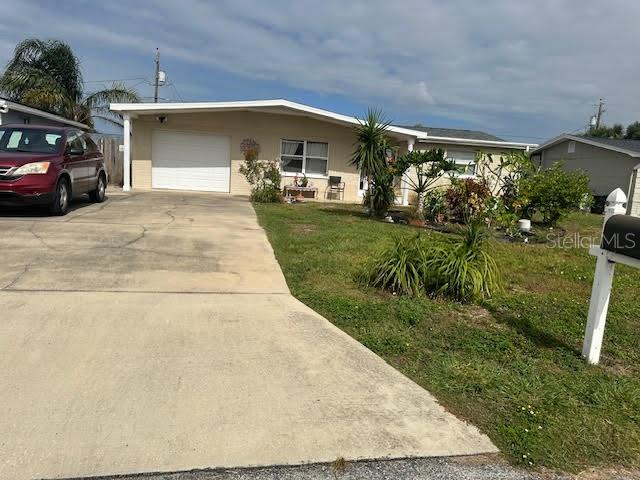 ranch-style house with a front yard and a garage