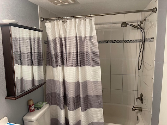 bathroom with a textured ceiling, toilet, and shower / bathtub combination with curtain