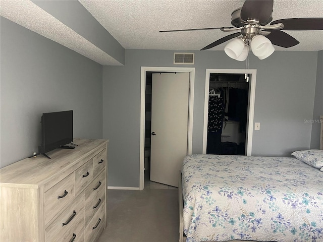 carpeted bedroom with a textured ceiling and ceiling fan