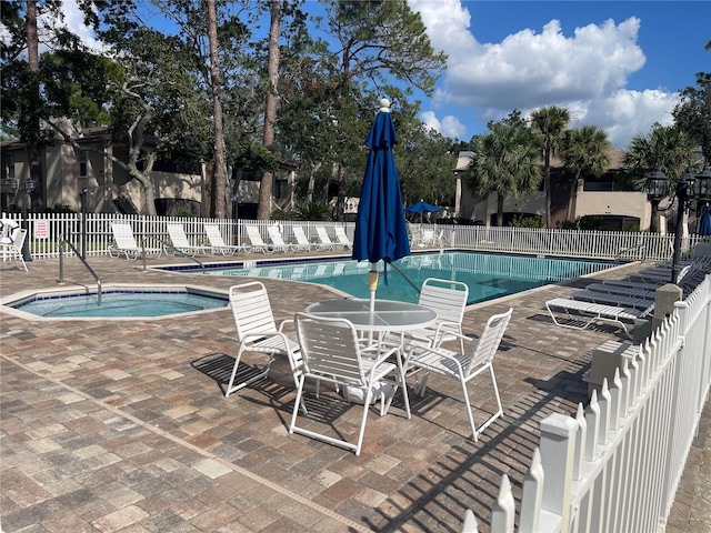 view of swimming pool with a community hot tub and a patio