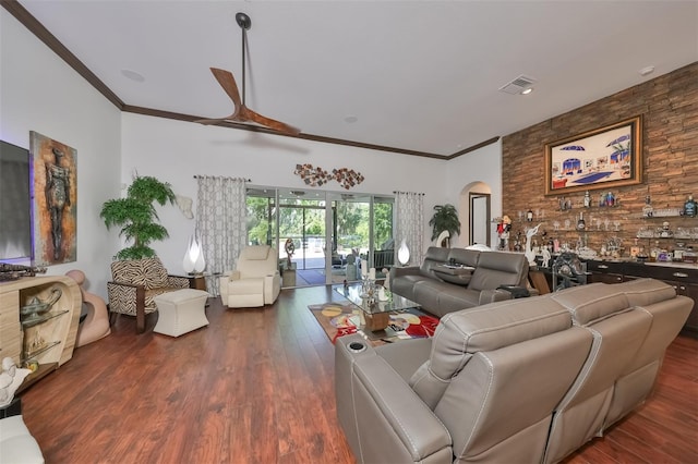 living room featuring ceiling fan, crown molding, and dark wood-type flooring