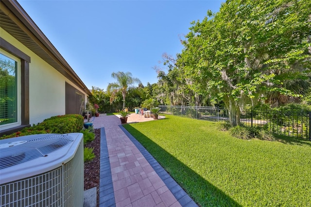 view of yard featuring a patio and central AC