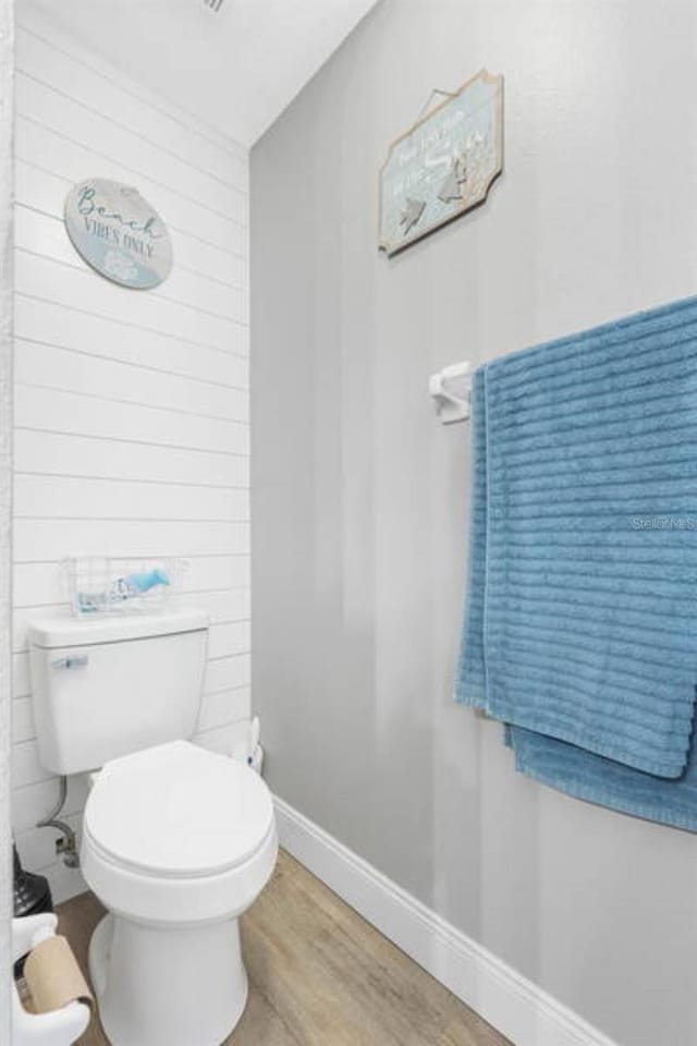 bathroom with wood-type flooring and toilet