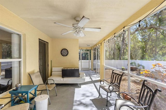 sunroom / solarium featuring ceiling fan