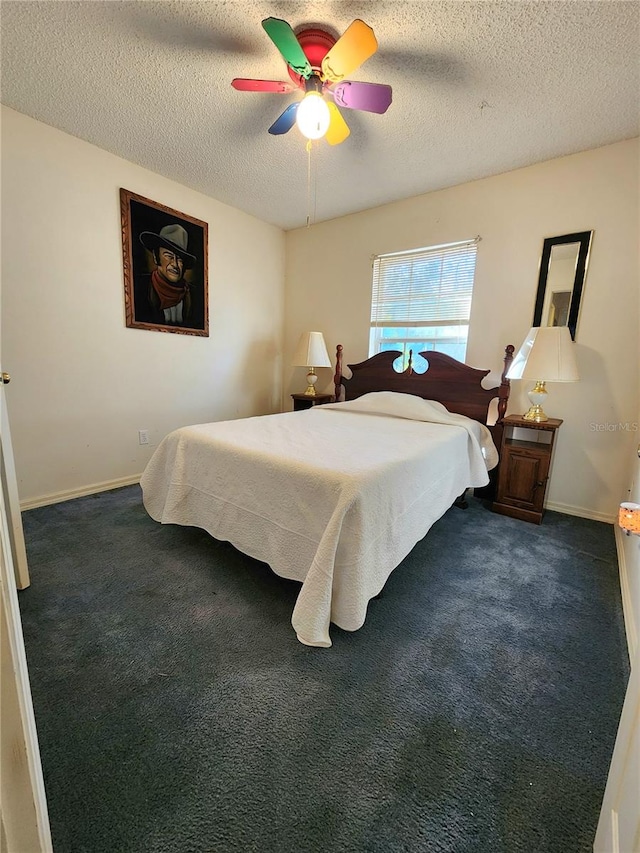 carpeted bedroom with ceiling fan and a textured ceiling