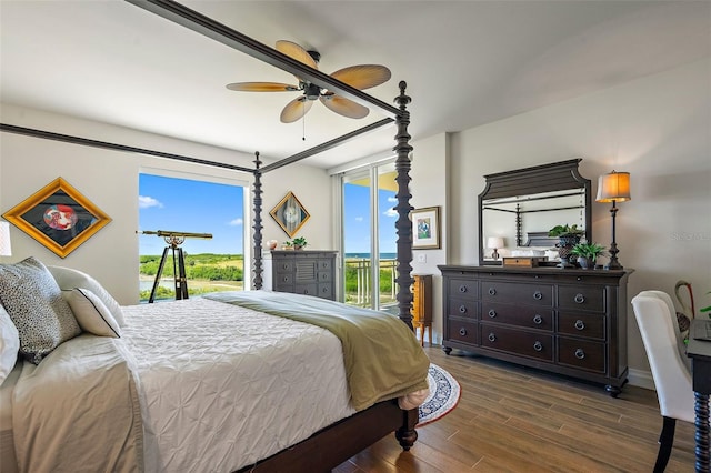 bedroom with access to exterior, ceiling fan, and dark wood-type flooring