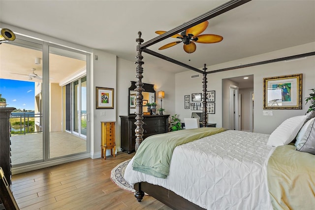 bedroom featuring hardwood / wood-style floors, ceiling fan, and access to outside