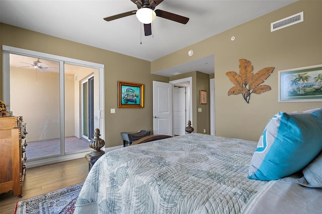 bedroom featuring hardwood / wood-style floors, a closet, ceiling fan, and access to outside