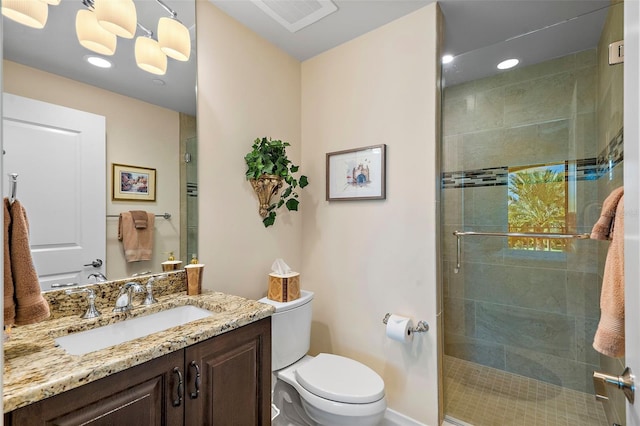 bathroom with vanity, an enclosed shower, and toilet