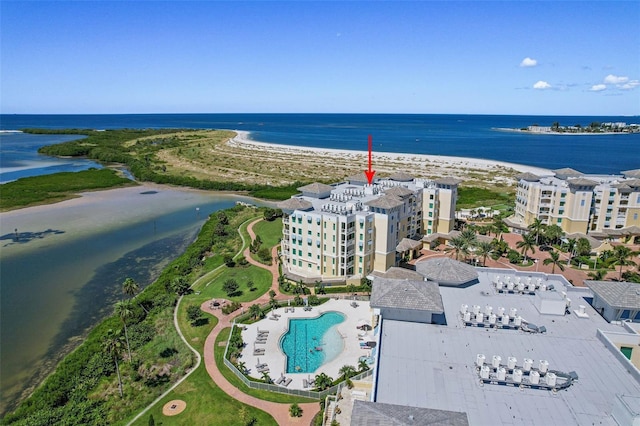 birds eye view of property featuring a water view and a beach view