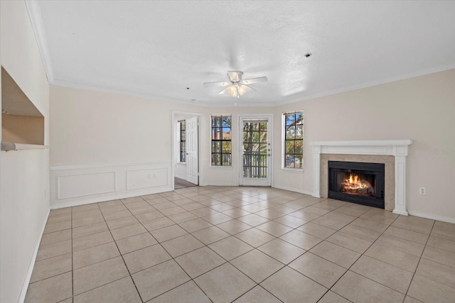 unfurnished living room featuring ceiling fan, light tile patterned flooring, and ornamental molding