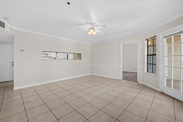 empty room featuring ceiling fan, ornamental molding, and light tile patterned flooring