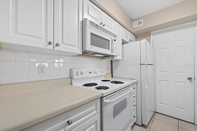 kitchen featuring light tile patterned flooring, white appliances, visible vents, white cabinetry, and light countertops