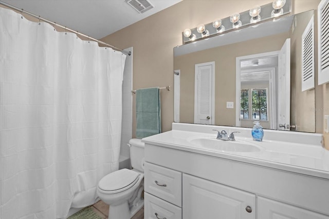 bathroom featuring toilet, a closet, vanity, and visible vents