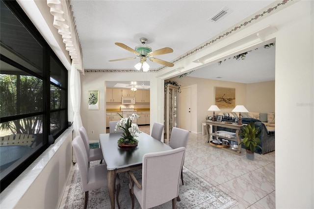 dining space featuring ceiling fan